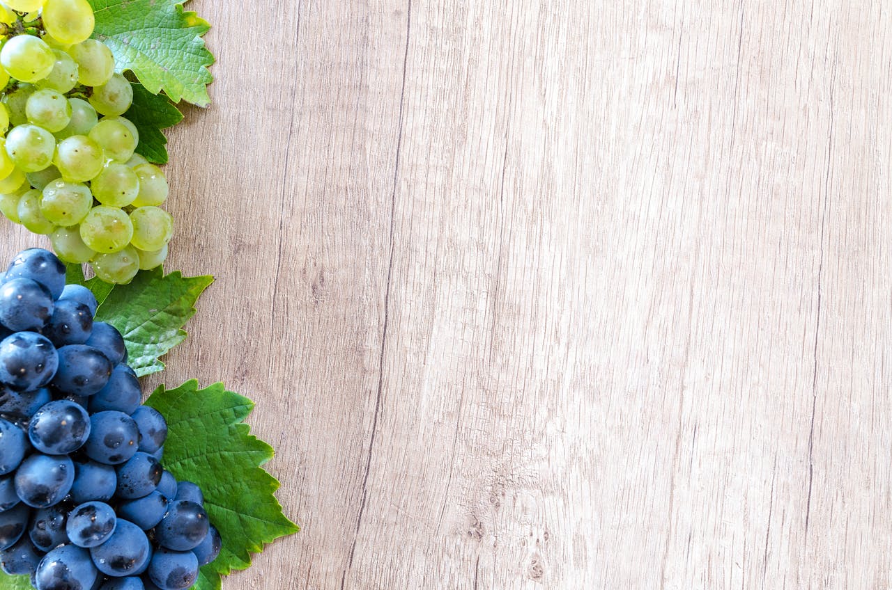 Colorful grapes on a wooden board, perfect for fresh food concepts.